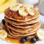 Banana Cottage Cheese Pancakes: Easy, Fluffy & High Protein Recipe 5 Banana cottage cheese pancakes stacked with banana slices and syrup