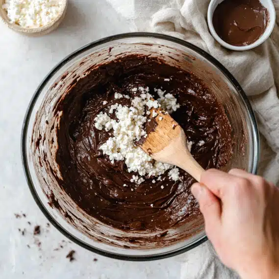 Cottage Cheese Brownies Recipe – Fudgy, Healthy & Protein-Packed 6 Mixing cottage cheese brownie batter in glass bowl