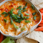 Cottage cheese buffalo chicken dip in cast iron skillet with chips