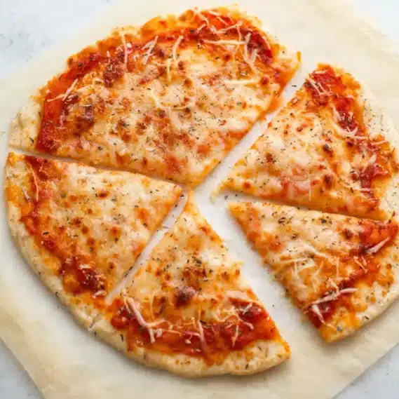 Cottage Cheese Pizza Crust – Easy High-Protein Recipe (20 Min) 4 Sliced cottage cheese pizza crust topped with pepperoni and melted cheese